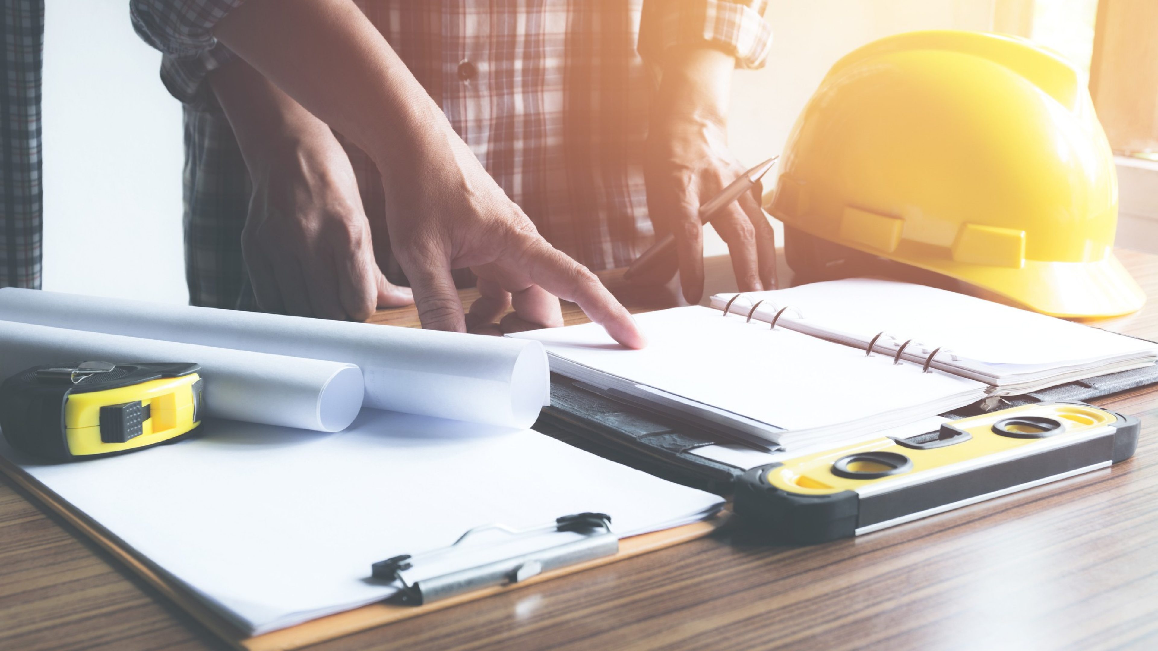 Architect engineer working concept and construction tools or safety equipment on table.