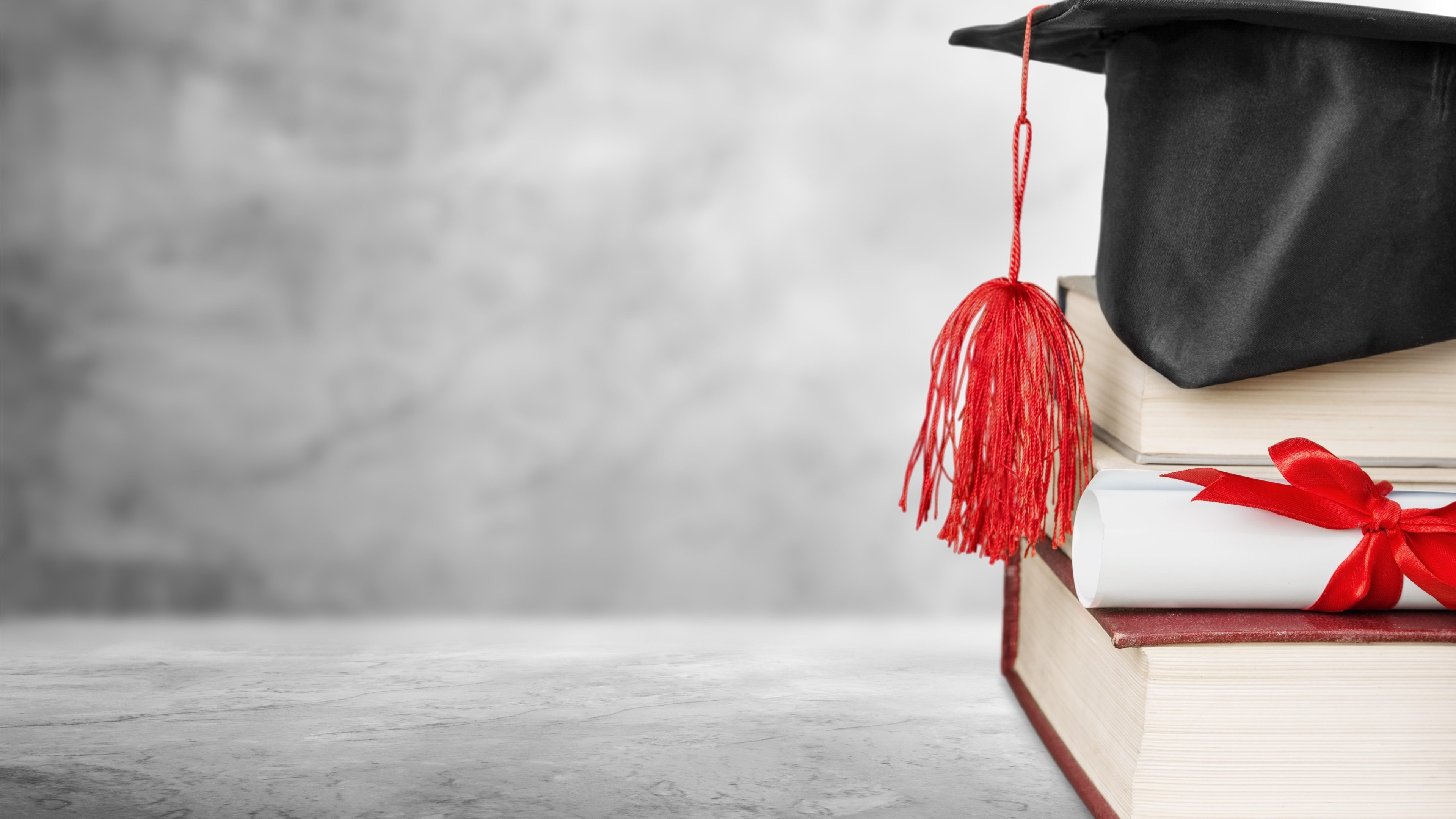 Graduation cap with books and Degree